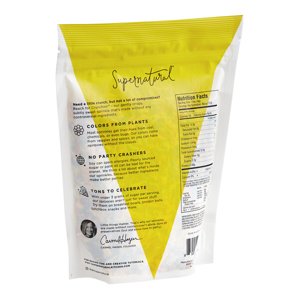 A yellow and white bag of Supernatural Rainbow Crunchies All-Natural Sprinkles with text and images.