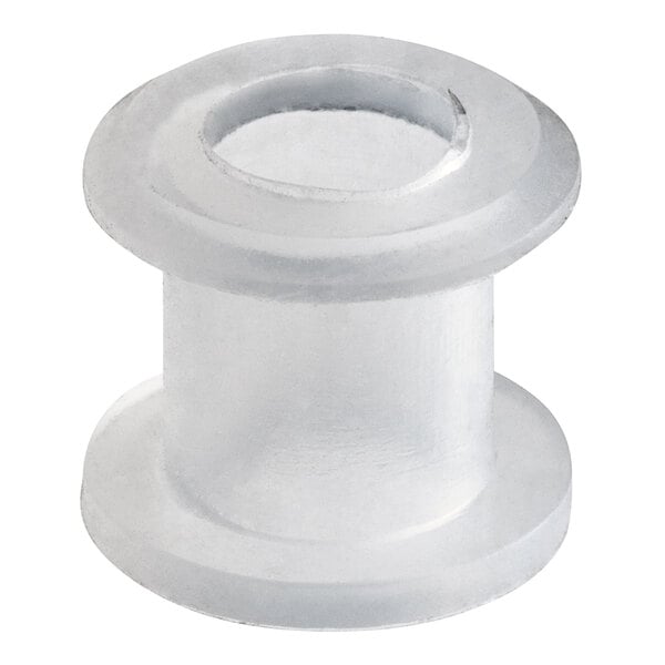 A close-up of a white rubber grommet with two holes.
