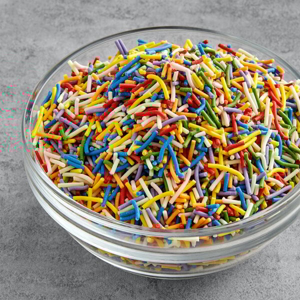 A bowl of Supernatural Rainbow Crunchies all-natural sprinkles in a variety of colors.