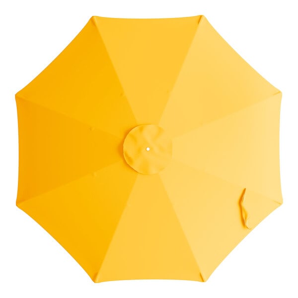 A yellow umbrella with a hole in the top.