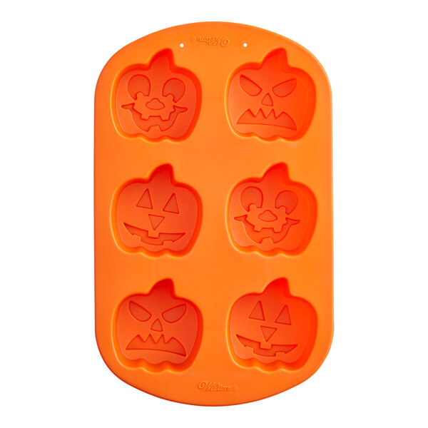 A Wilton silicone baking mold with 6 carved pumpkin shapes.