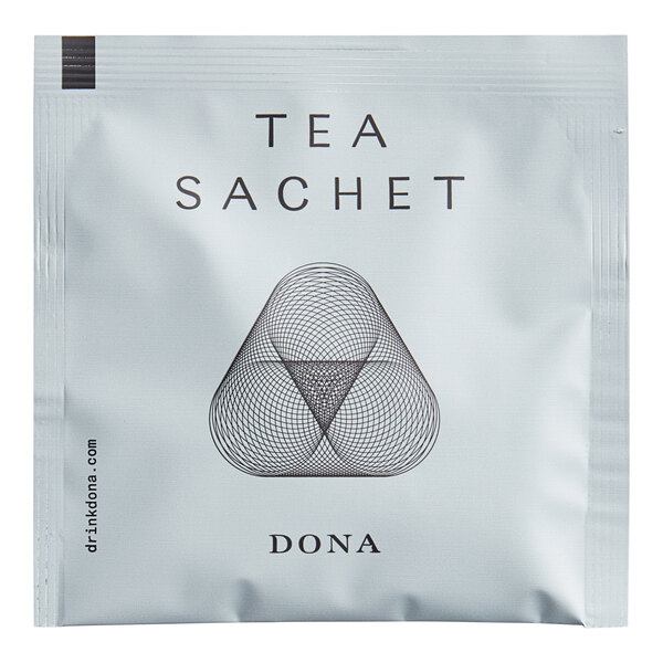 A white Dona package of black and amber triangle shaped tea sachets.