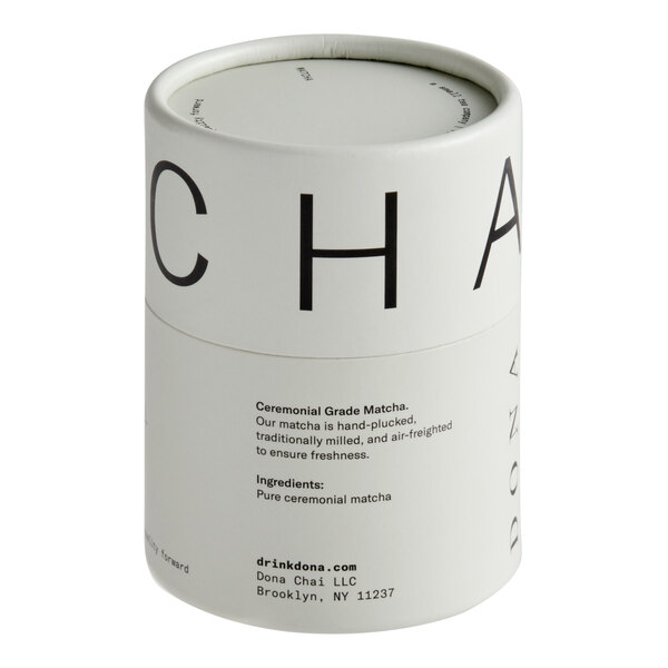 A cylindrical tin of Dona Ceremonial Matcha Powder containing 30 grams (1.06 oz.).