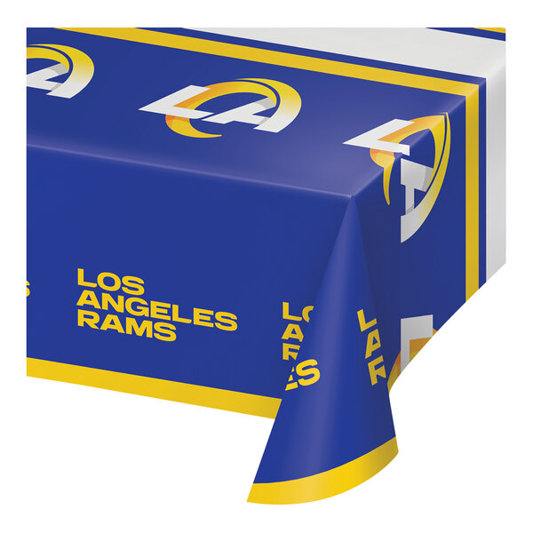 A blue and yellow Creative Converting Los Angeles Rams table cover on a table.