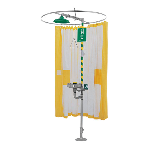 A Haws emergency shower with a green and yellow modesty curtain.