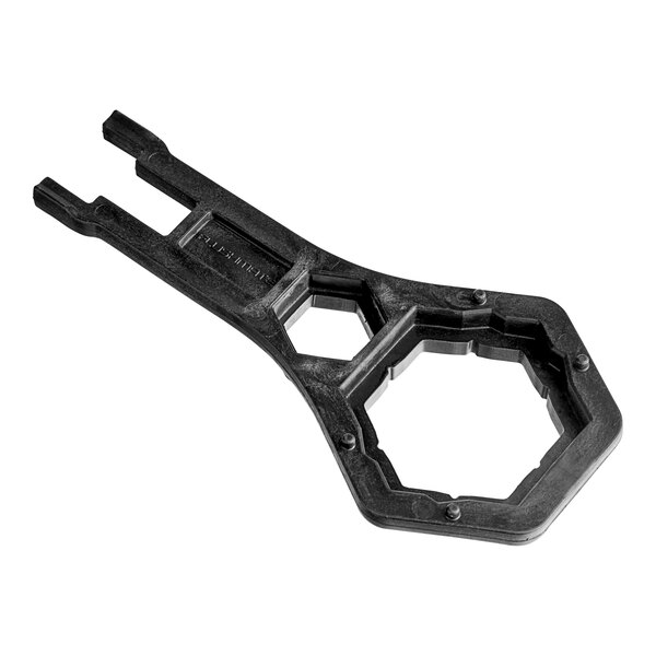 A black plastic tool with a hexagon shape and holes.