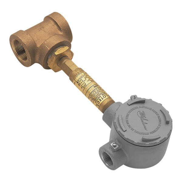 A close-up of a grey metal Haws flow switch with a gold label.