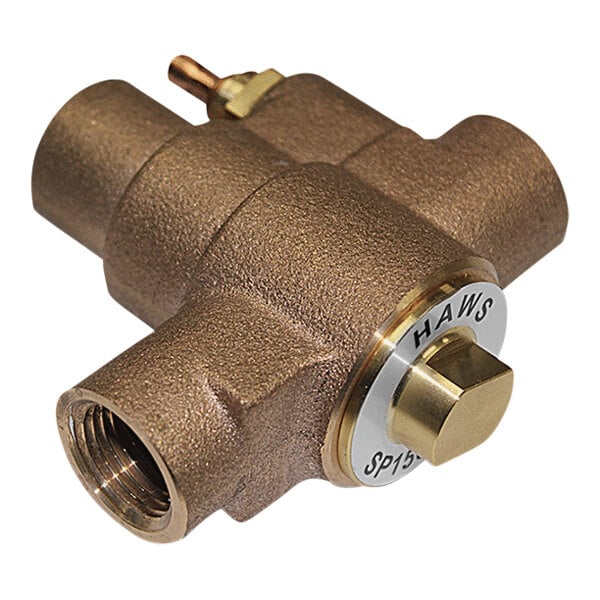 A brass Haws freeze-protection bleed valve with a brass handle.