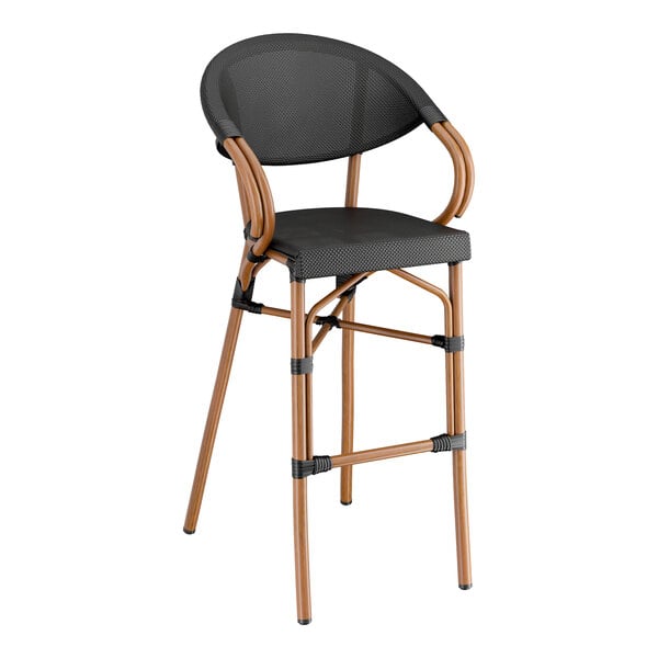 A Lancaster Table & Seating outdoor arm barstool with a black Teslin seat and wooden frame.