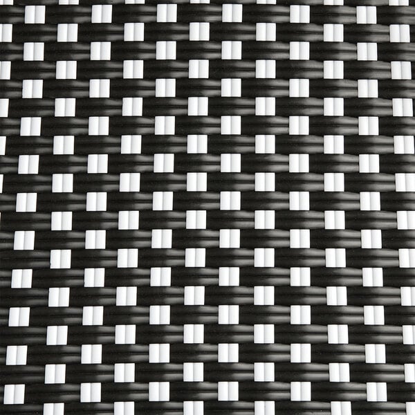 A black and white woven rattan backless barstool.