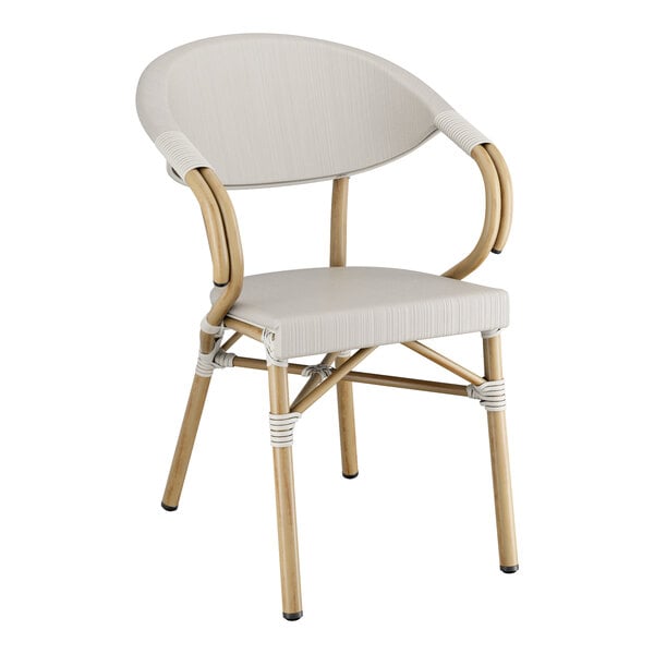 A Lancaster Table & Seating outdoor arm chair with a white cushion