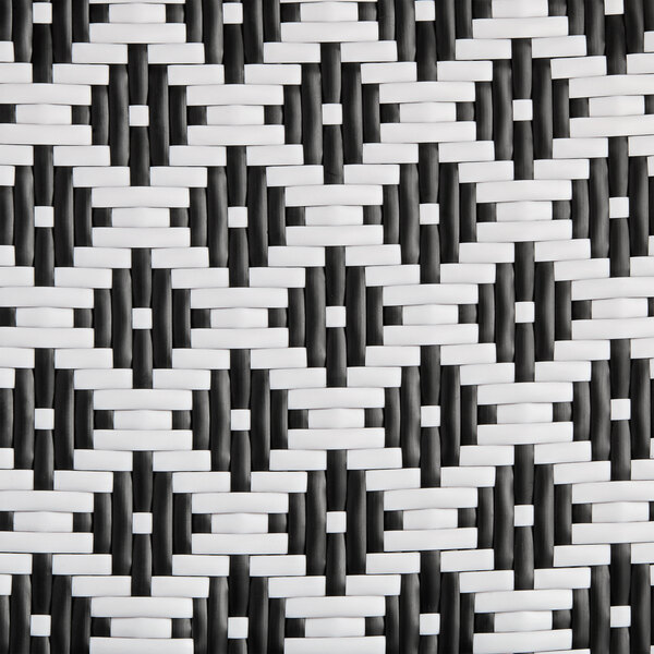 A close up of a Lancaster Table & Seating black and white birdseye weave rattan outdoor side barstool.