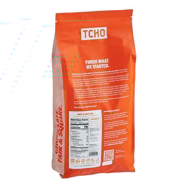 A close-up of a bag of TCHO Sweet & Sassy 66% Dark Chocolate Hexagons with white text.