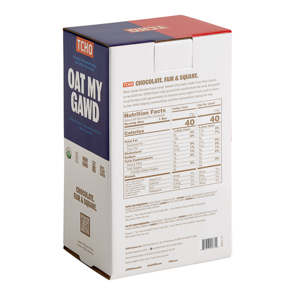 A white box with blue and red text that reads "TCHO Oatally Awesome Assorted Oat Milk Chocolate Squares" on a store counter.