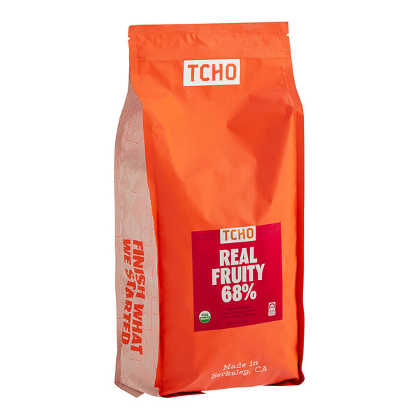 A close up of a bag of TCHO Real Fruity 68% Dark Chocolate Hexagons with a red label.