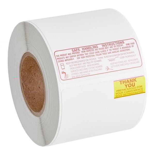 A white roll of Toledo Safe Handling Scale labels with red text.