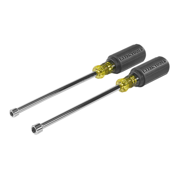 A close-up of two Klein Tools screwdrivers with yellow handles and magnetic tips.