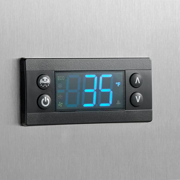 A digital temperature control panel on a stainless steel refrigerated chef base.