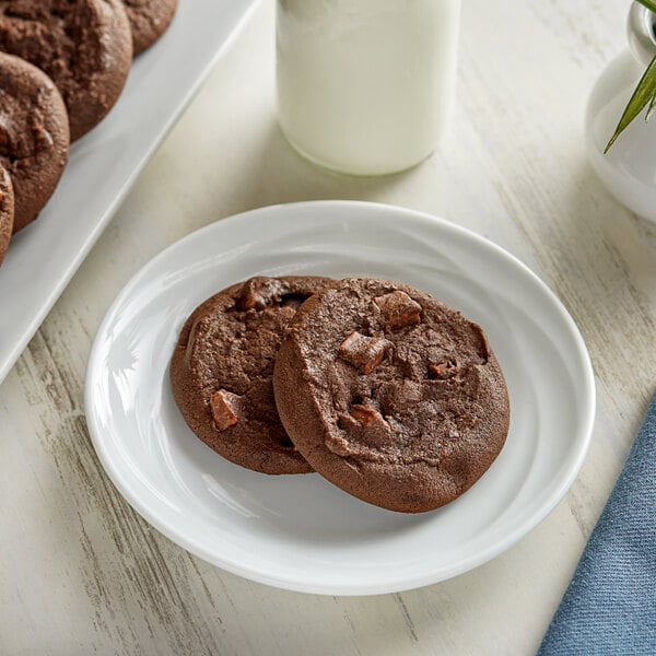 A close-up of a chocolate chip cookie on a plate.