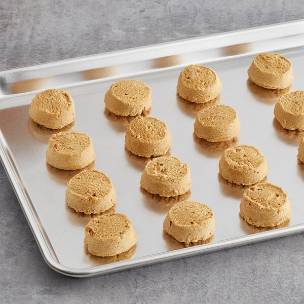 Preformed Otis Spunkmeyer peanut butter cookies on a tray.