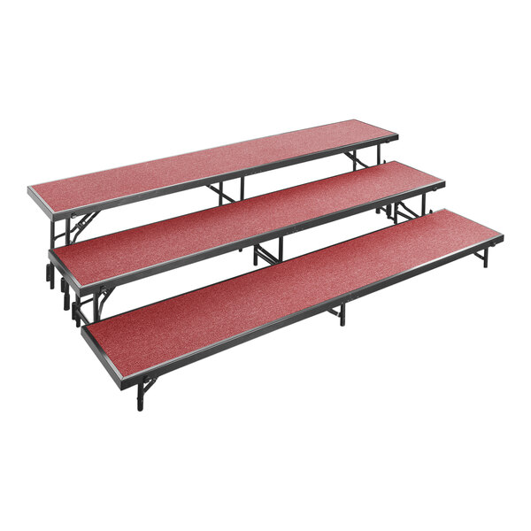 A red rectangular National Public Seating choral riser with metal legs and red carpeted levels.