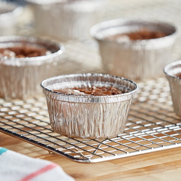 A group of Baker's Lane foil ramekin cups on a cooling rack.