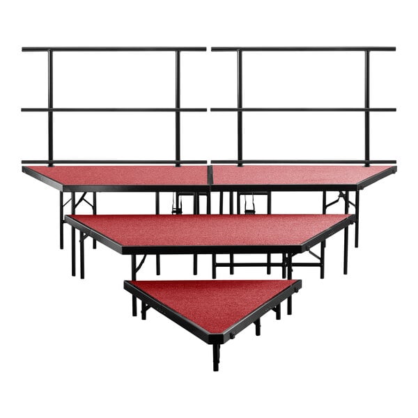 Three red National Public Seating stage risers with a red carpet top.