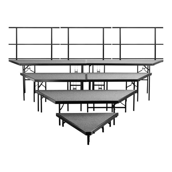 A group of grey stage risers with metal legs.