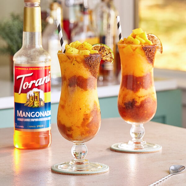 Two glasses of fruity drinks with Torani Mangonada syrup.