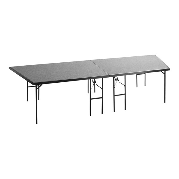 A National Public Seating rectangular gray stage pie on folding legs.