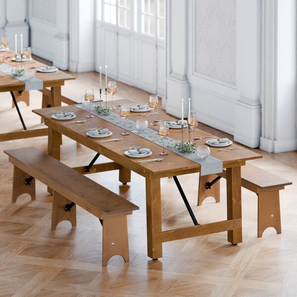 A Lancaster Table & Seating Vineyard Series outdoor table with benches on a wooden floor.