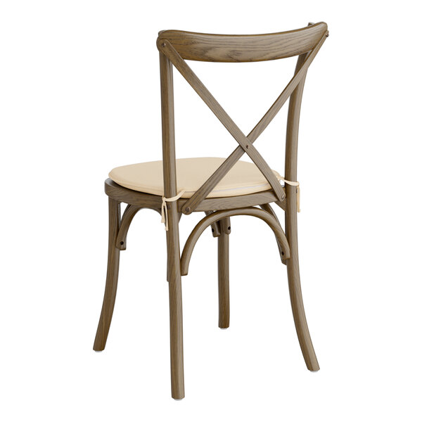 A Lancaster Table & Seating Vineyard Series Whiskey Brown Outdoor Cross Back Chair with a Chardonnay Tan Linen Cushion.