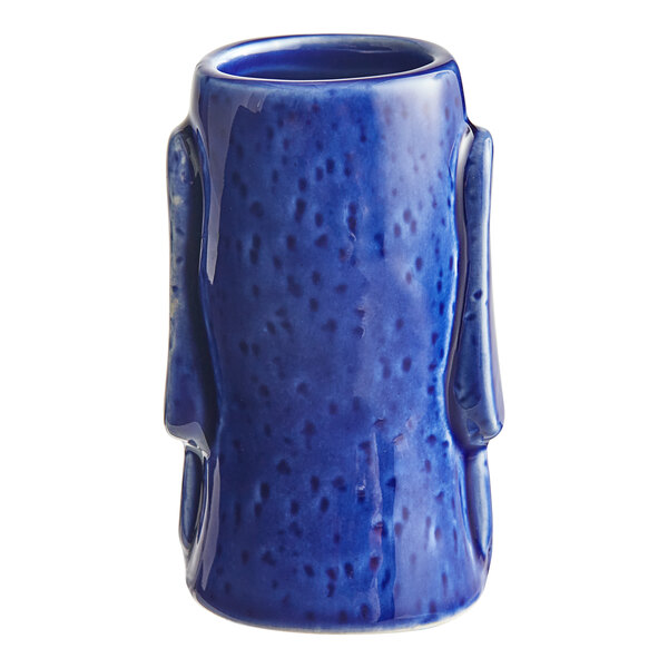 An Acopa blue ceramic shot glass with a handle.