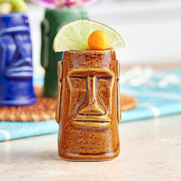 A brown Acopa ceramic Tiki mug with a lime wedge on top.