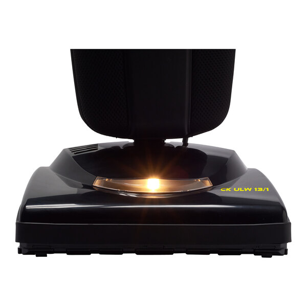 A close up of a Tornado bagged upright vacuum cleaner with a yellow light on it.