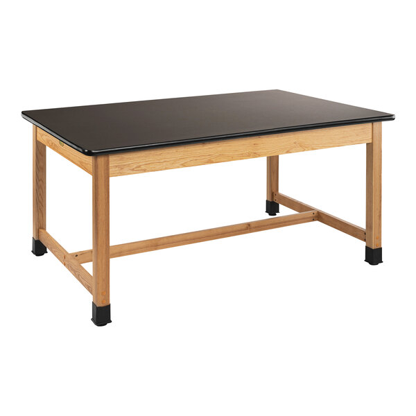 A black rectangular table with wooden legs and a black high-pressure laminate top.