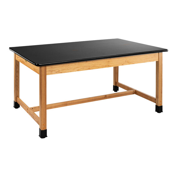 A black rectangular table with wooden legs and a black high-pressure laminate top.