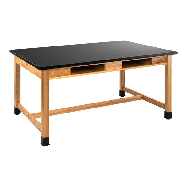 A black science lab table with a wood surface and built-in book compartments.