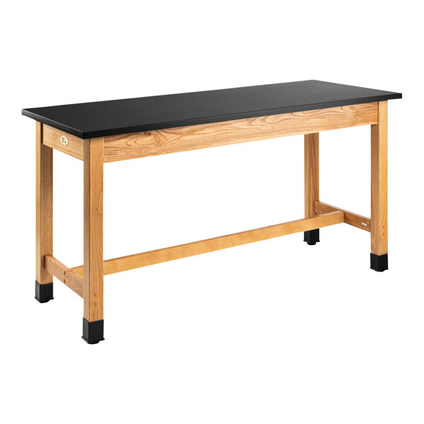 A black National Public Seating science lab table with wooden legs.