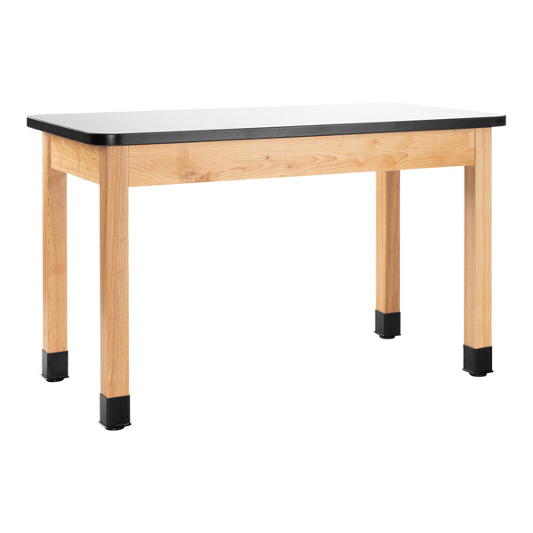 A wooden National Public Seating science lab table with a black top.