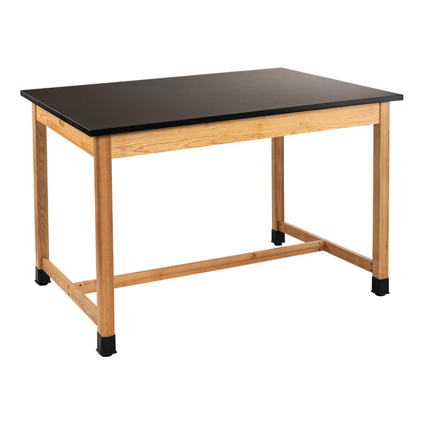A black National Public Seating science lab table with wooden legs and a wood top.