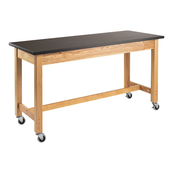 A wooden National Public Seating science lab table with black casters.