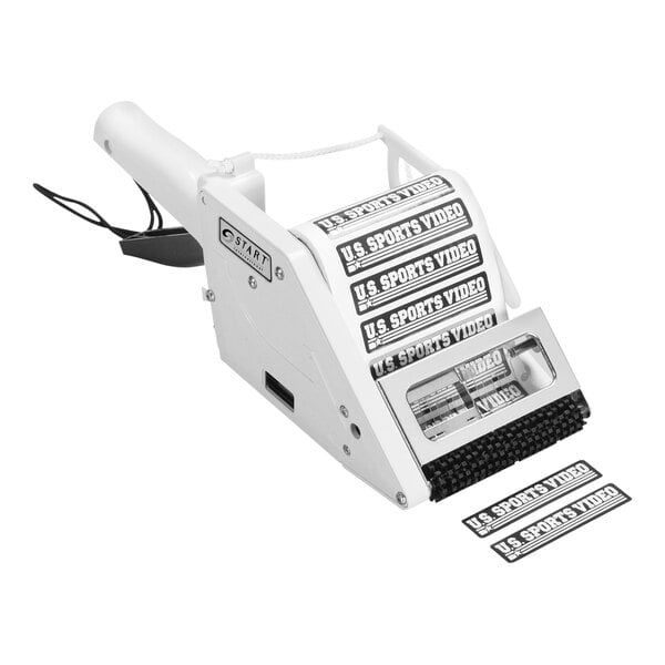A white Start International manual label applicator with a black label on it.