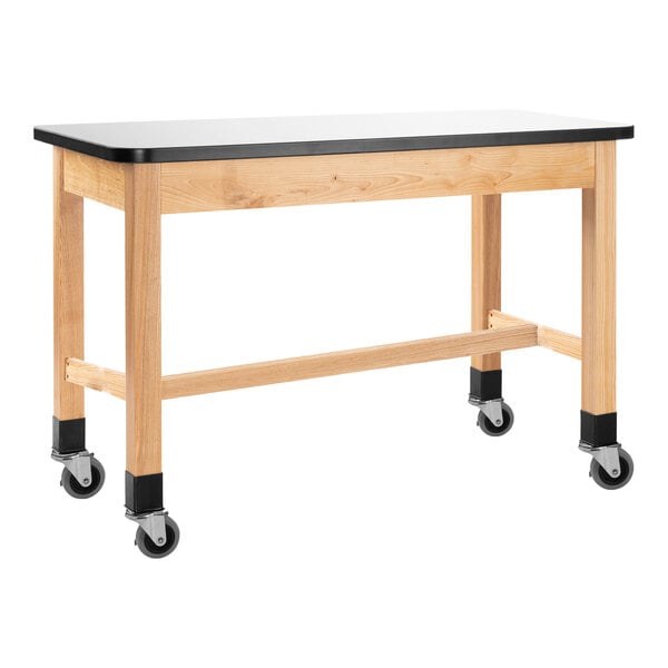 A wooden science lab table with a whiteboard top and wheels.