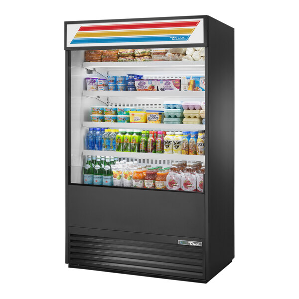A True refrigerated air curtain merchandiser with food on shelves.