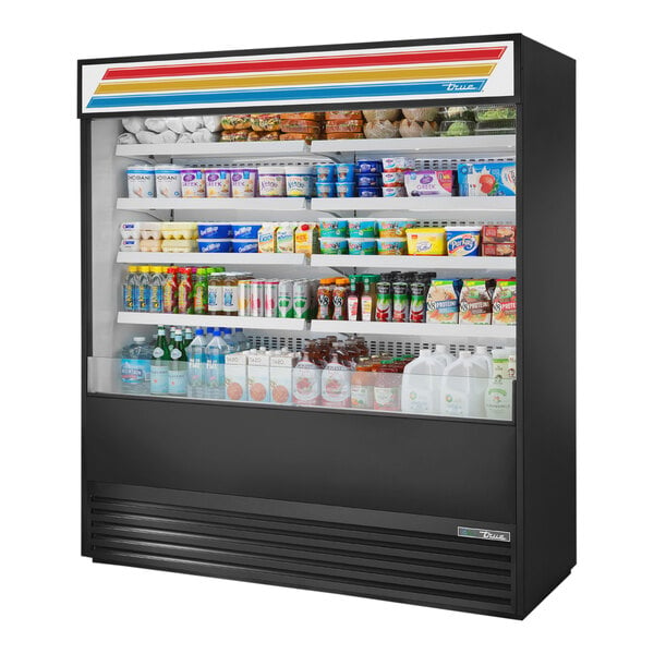 A True refrigerated air curtain merchandiser with a variety of products inside.