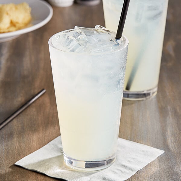 A glass of Jones Left Coast Lemonade with a straw and ice.