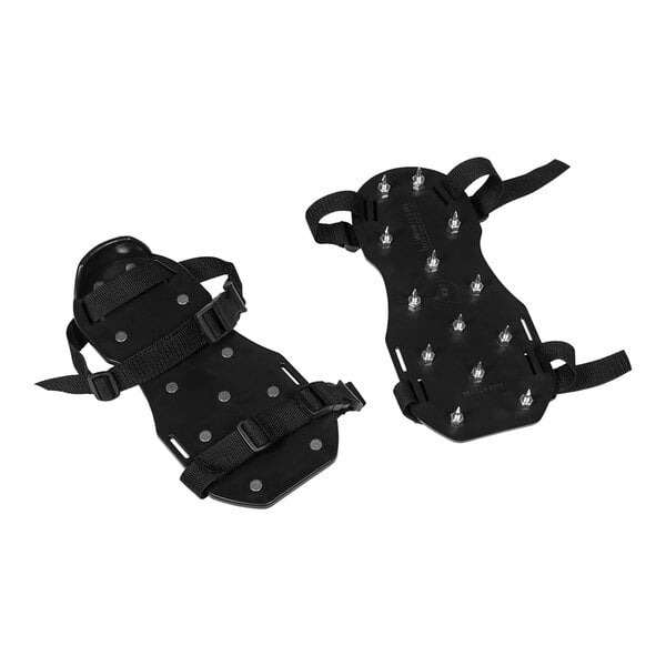 A pair of black overshoes with metal spikes on the sole.