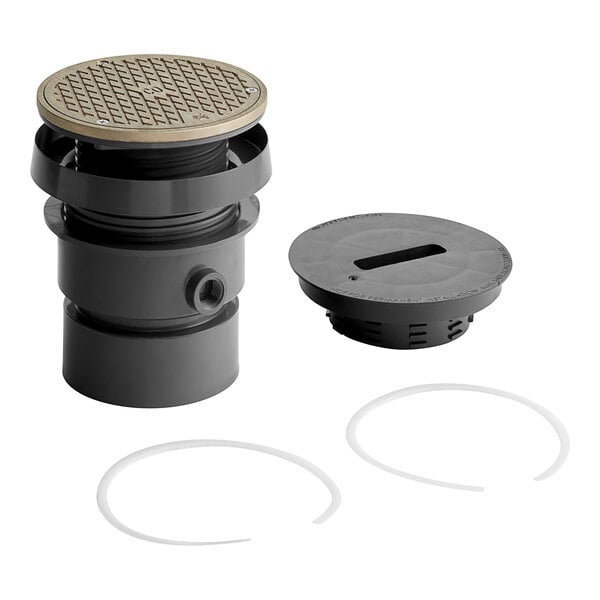 A grey plastic Sioux Chief medium-duty adjustable floor drain with a round lid and a round hole.