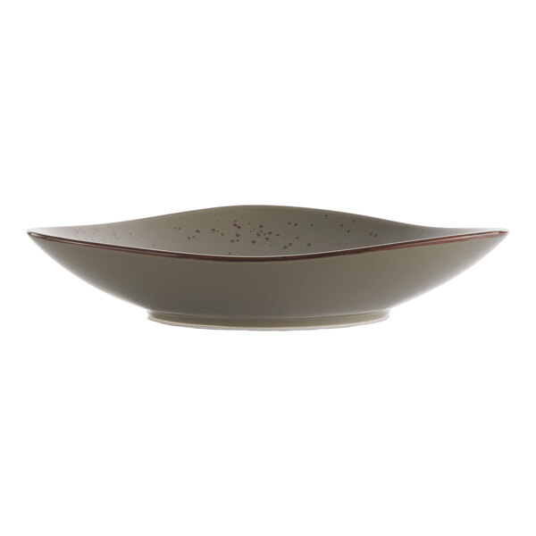 A white bowl with green and brown specks.